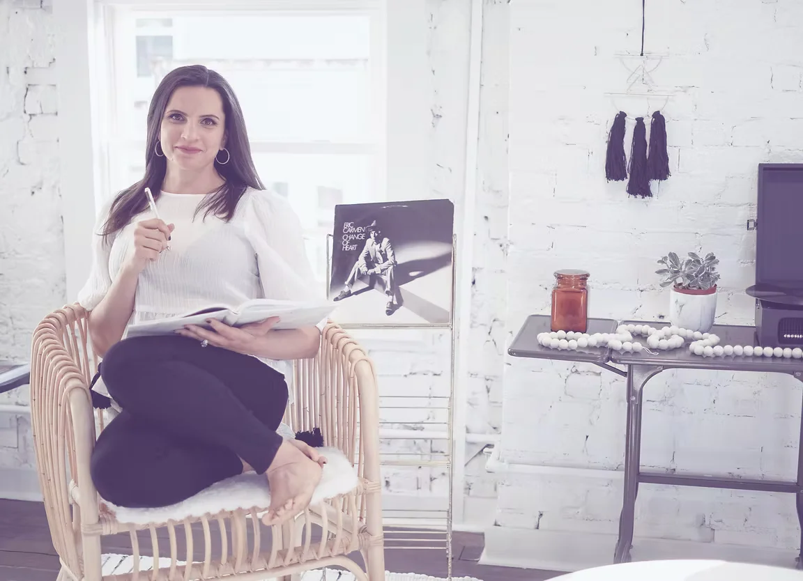 Christina seated in her office, wide view of the room